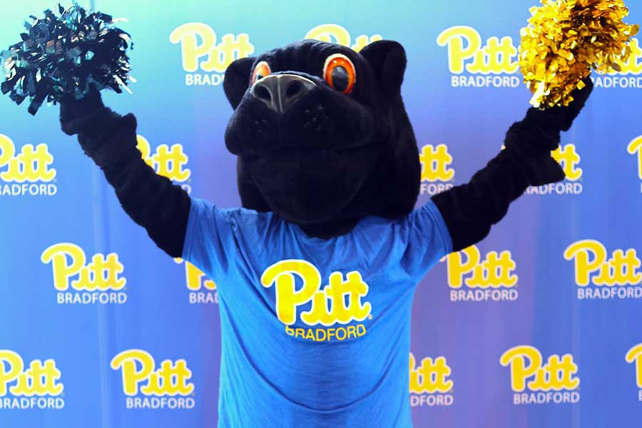 Panther mascot standing with pom-poms in hands