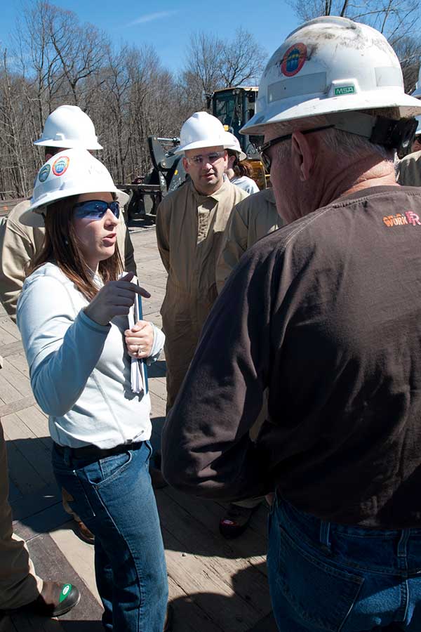 Student speaking with oil producer