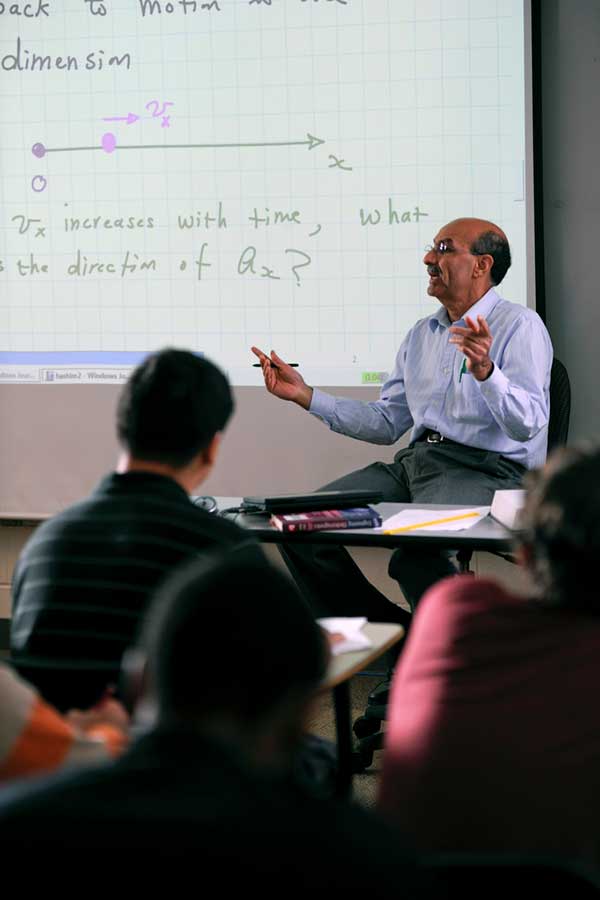 Professor in front of desk