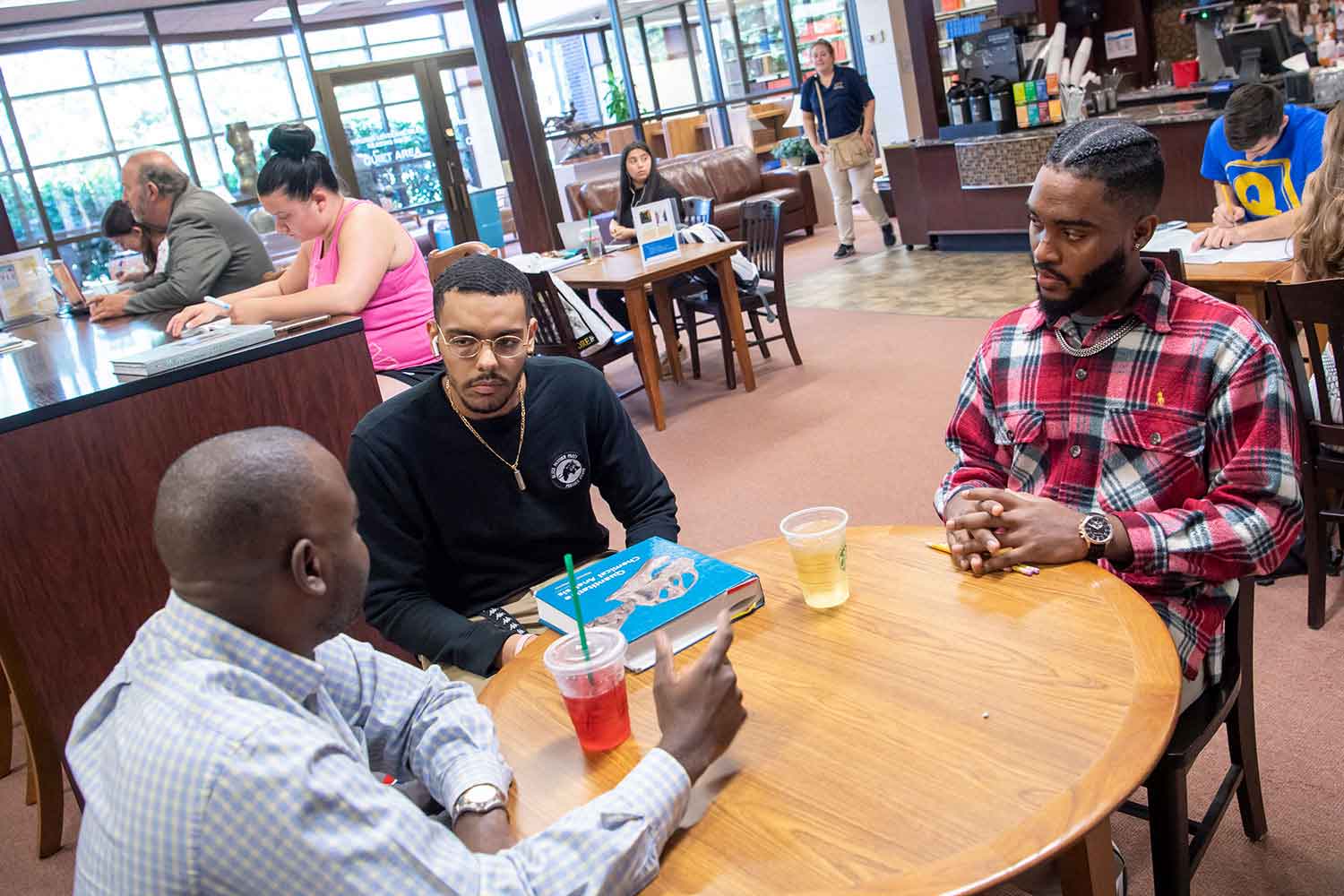 Professor with students in lounge