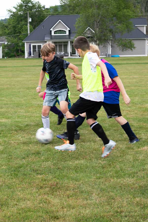 Kids playing soccer at a soccer camp