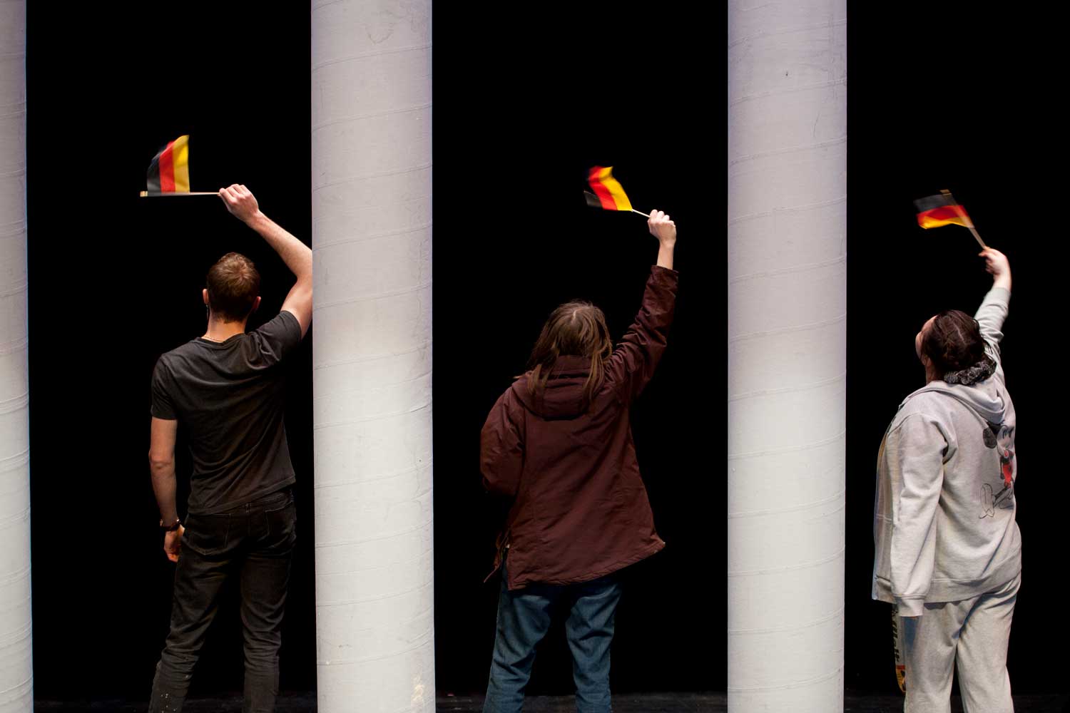 Students acting on stage waving flags