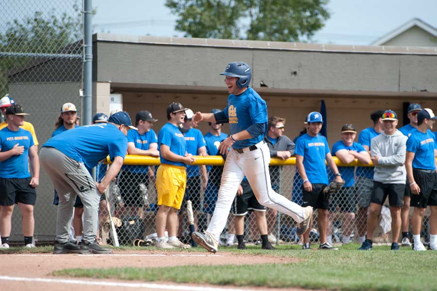 Baseball players high-fiving by the bases