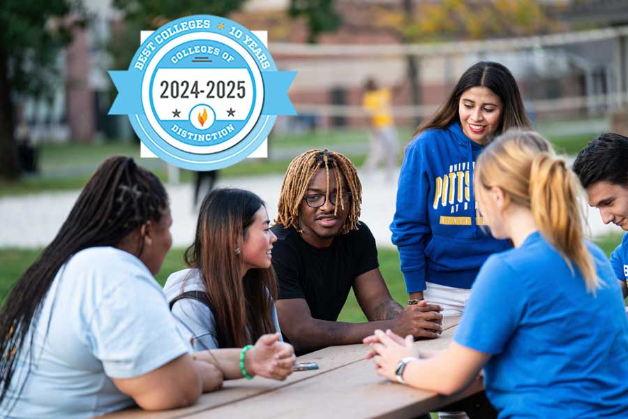 Students around a picnic table talking, with college of distinction badge