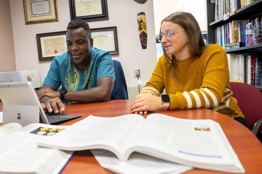 Instructor with student at table