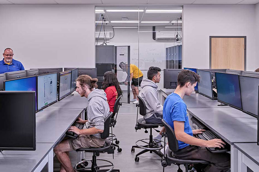 Students in a room with many computers