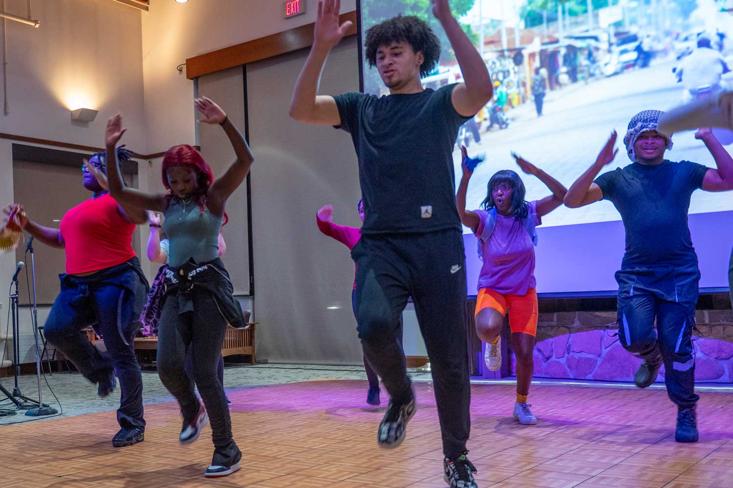 Students and  performers dancing on a stage