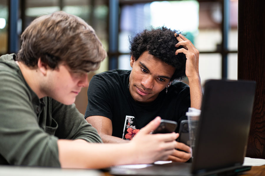 Two students looking at a phone