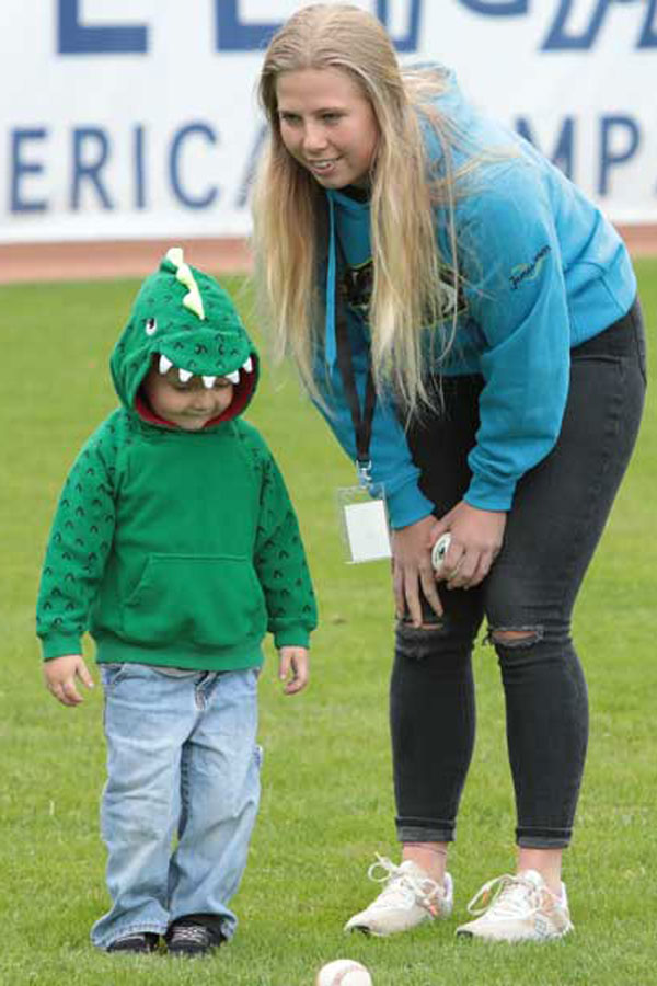 Ashton Beckerink with a child in a baseball field