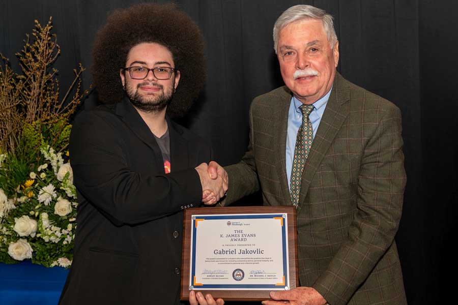 Gabriel Jakovlic stands with James Evans for his award