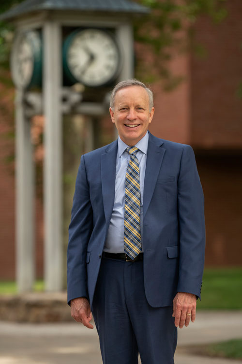 President Rick Esch in front of clock tower