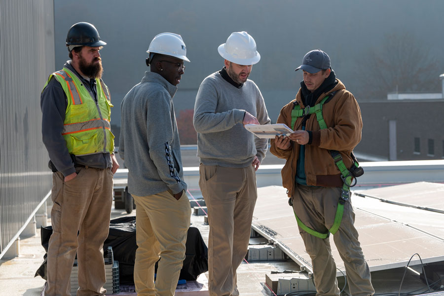 Dr. Matthew Kropf and others working on roof