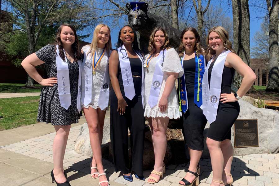 Six nursing graduates with panther