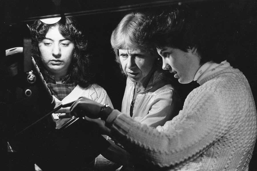 Dr. Patty Bianco, professor emeritus of theater, works with students backstage in O'Kain Auditorium.