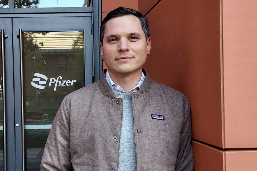  Dr. John Androsavich standing in front of a door with "Pfizer" written on the door pane