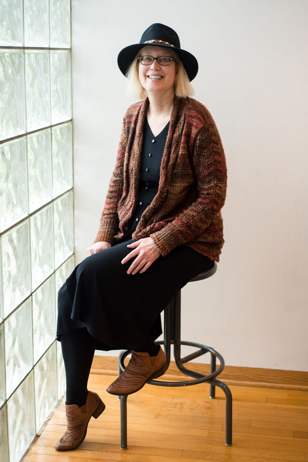 Dr. Nancy McCabe sitting in front of a window