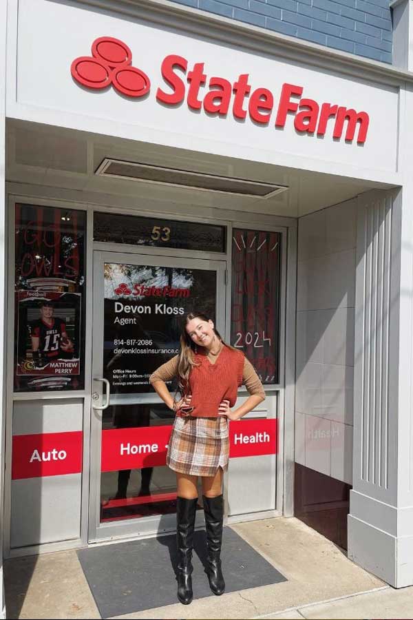 Student standing outside of insurance building