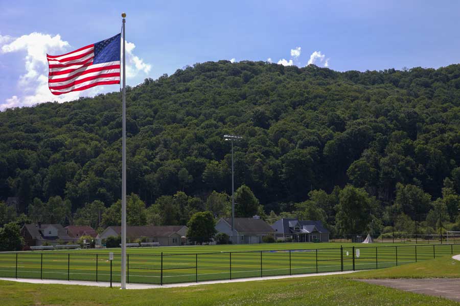 An American Flag waving above UPB turf field