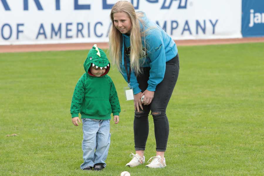 Ashton Beckerink with a child in a baseball field