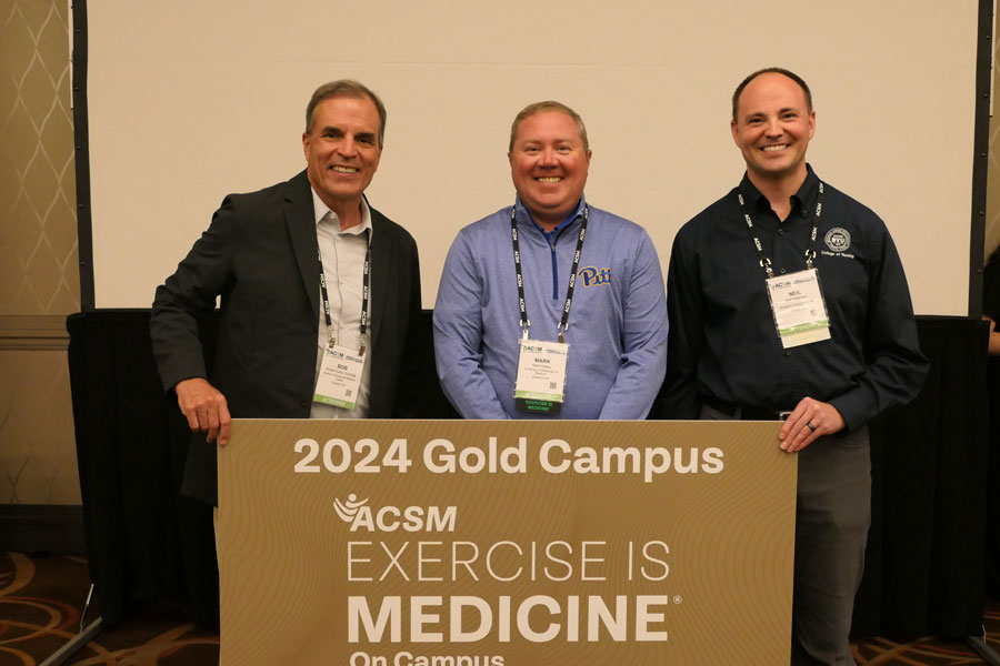 Mark Kelley accepting gold campus award for exercise science