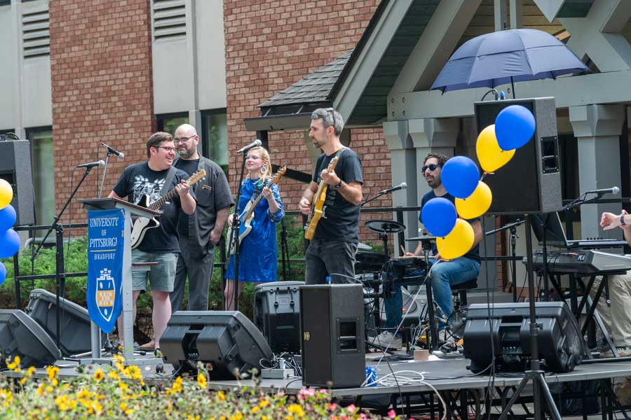 the faculty-staff band "Slick" playing on stage