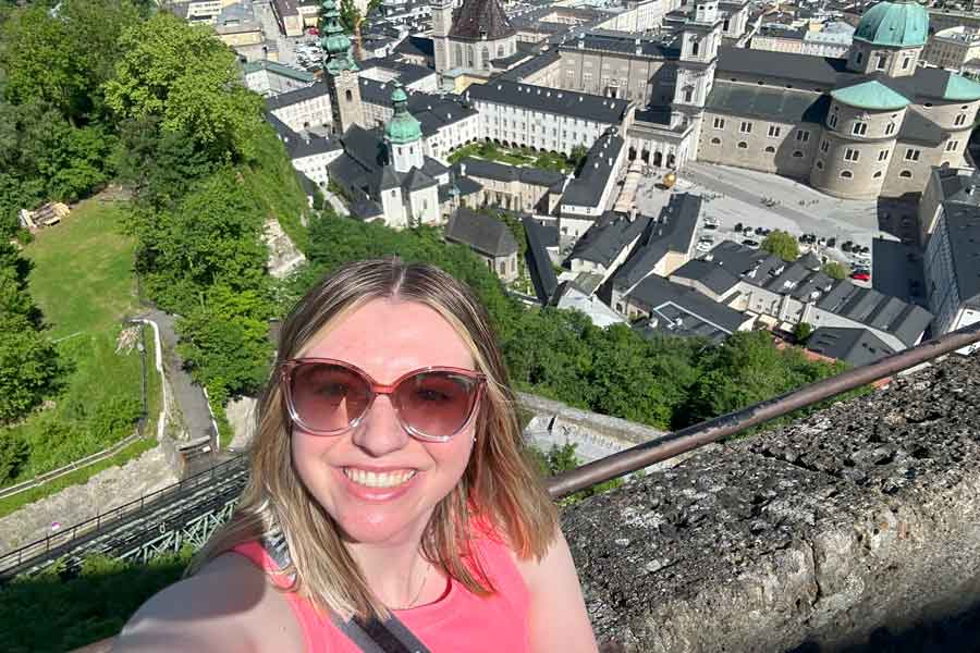 Madison Miller taking a selfie above a town in Europe