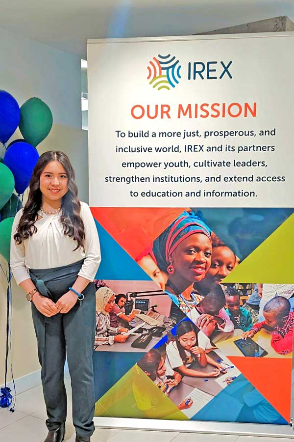 Ezoza standing next to an IREX sign