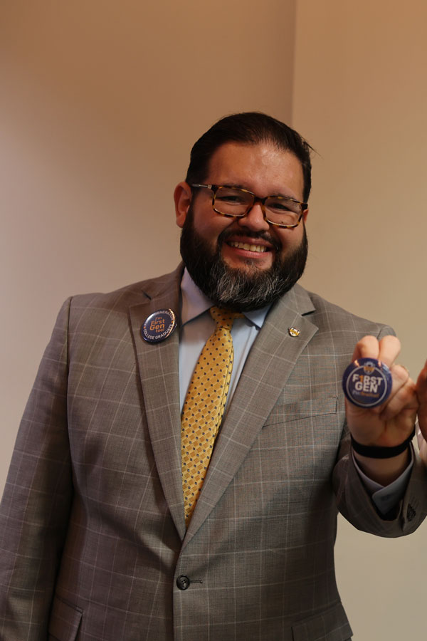 Luis smiling and holding a First-Gen pic