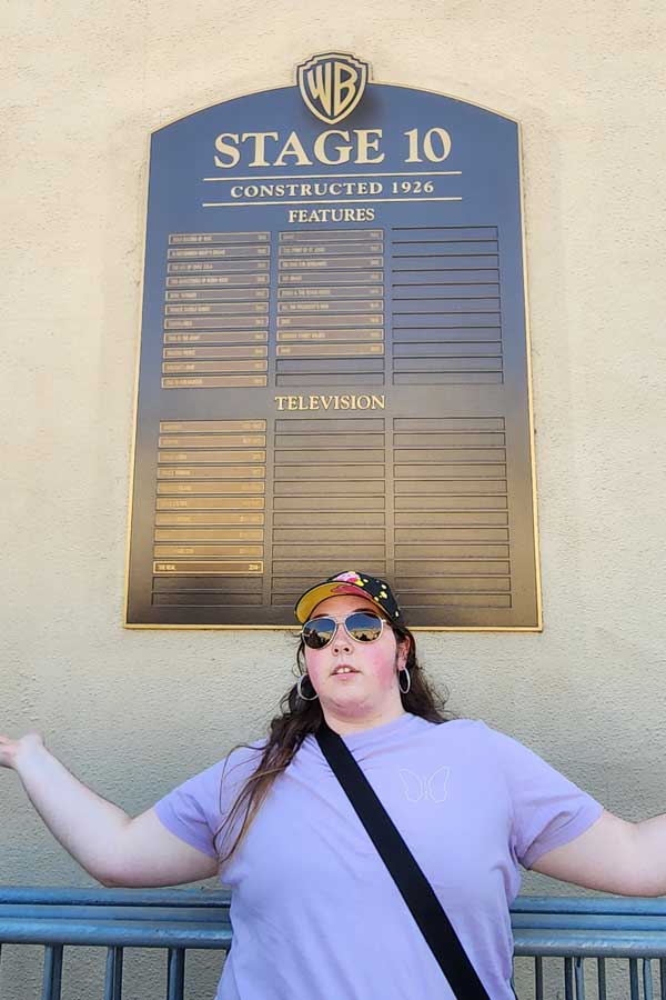 Louissa in front of a Stage 10 sign at Warner Brothers Studio