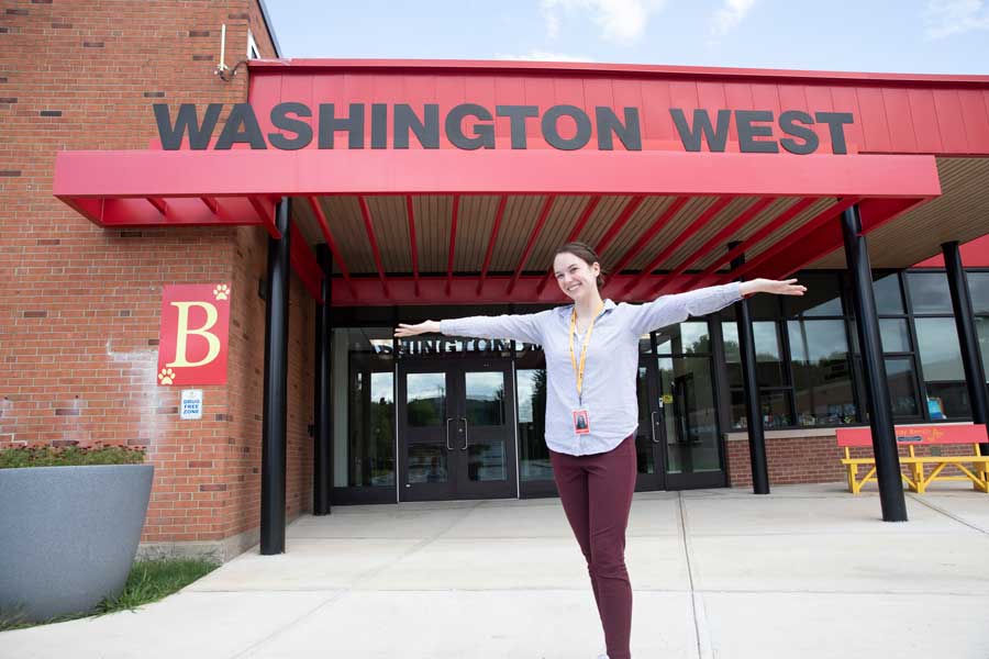 Gretchen standing in front of a school