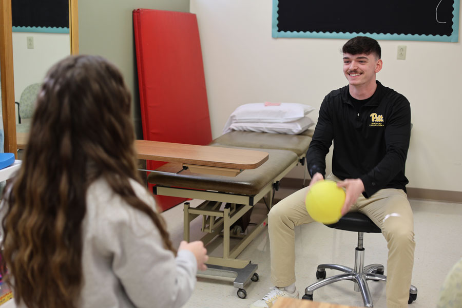 Logan working with an occupational therapist