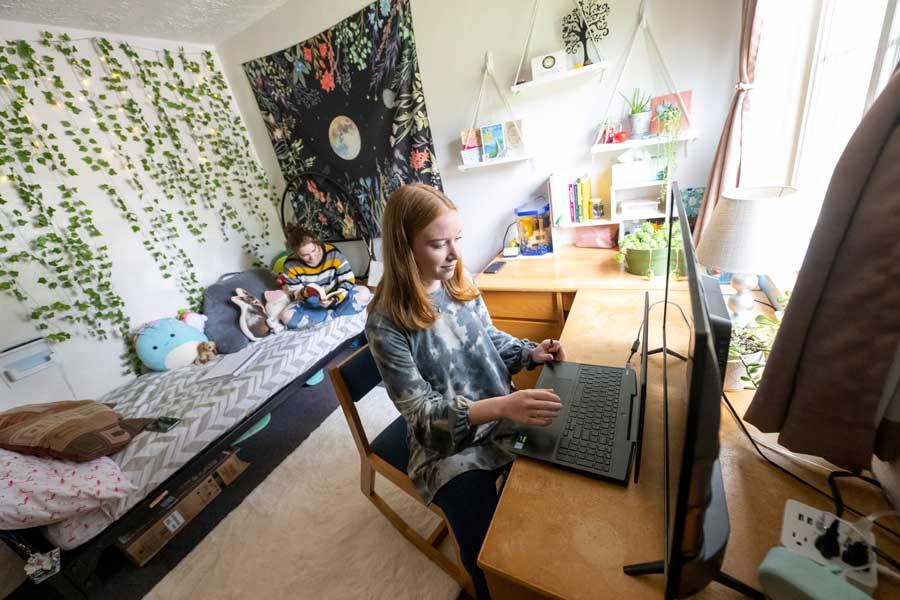 Student working at her desk in her dorm room