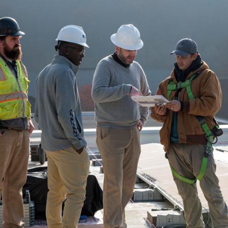 Dr. Matthew Kropf and others working on roof